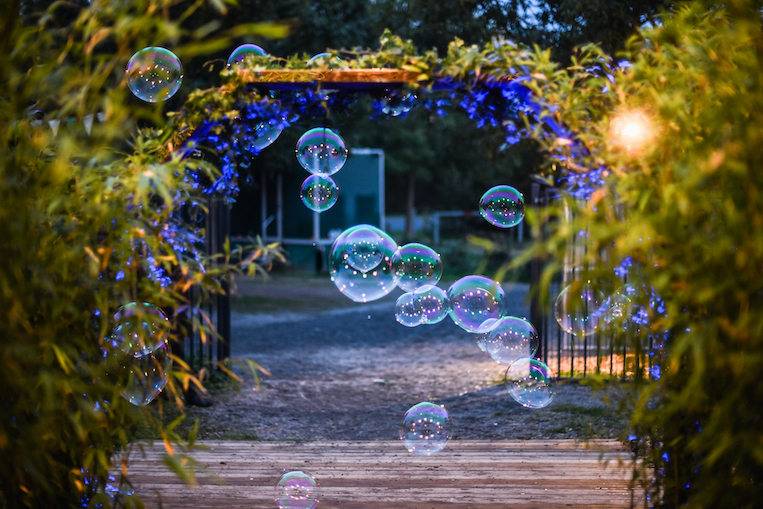 Bulles flottant dans une allée arborée